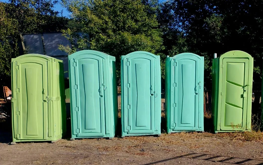 Fila de baños portátiles al aire libre